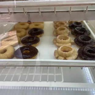 a variety of donuts in a display case