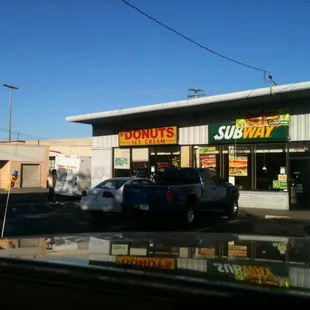 a car parked in front of a donut shop