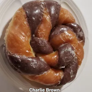 a chocolate covered doughnut on a white plate