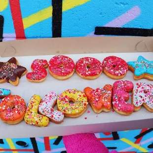 a box of doughnuts with sprinkles