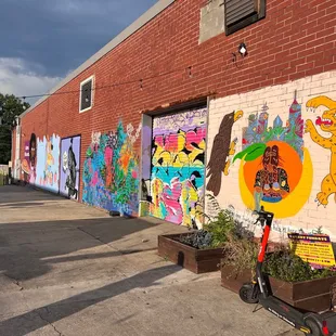 a brick building with a colorful mural on the side