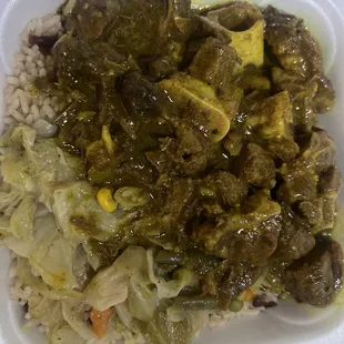 Curry Goat with cabbage rice and peas