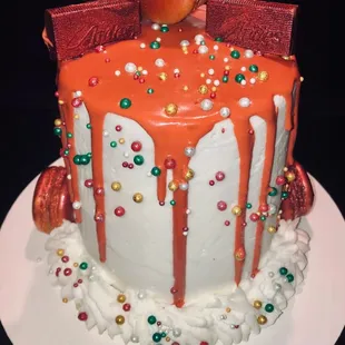a birthday cake with orange icing and decorations