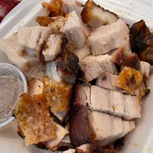 a plate of pork and other meats