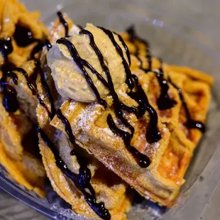 a waffle with ice cream and chocolate sauce