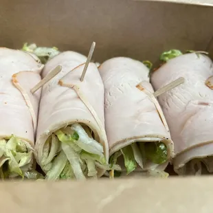 a box of sandwiches with toothpicks