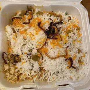 a takeout container of rice and vegetables