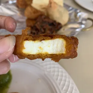 a person holding a piece of food