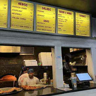 a man behind the counter of a restaurant