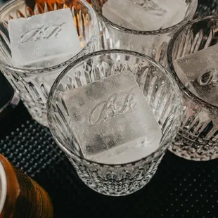 a close up of four glasses with ice cubes