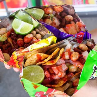 Takis locos, hot cheetos locos and tosti locos(chips,peanut,pickle pork skin,mango cucumber, tamarindo candy,chili powder, sour sauce)