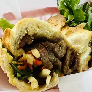 a sandwich with meat and vegetables