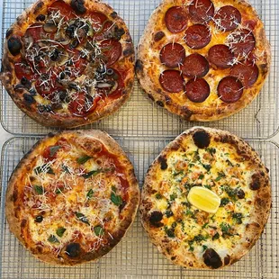 three pizzas on a cooling rack