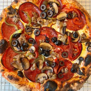 a pizza on a cooling rack