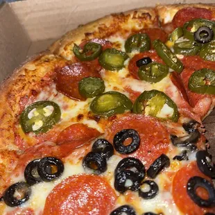 Pepperoni with half black olives and jalapeños