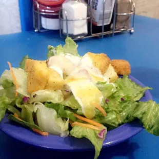 a salad on a blue plate