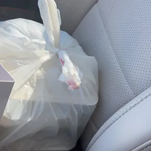 a bag of food in the passenger seat of a car