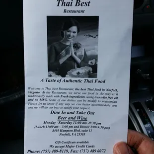 a hand holding a menu