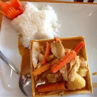 a plate of food with rice and carrots
