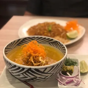 a bowl of soup and a plate of noodles