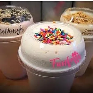 three cups of ice cream with sprinkles