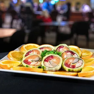 The Poker Room Roll - Tuna, Salmon, Krab Stick, Yellowtail, and Shrimp wrapped in Cucumber and Seaweed and served with Sweet Vinegar Sauce.