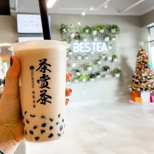 a hand holding a cup of bubble tea