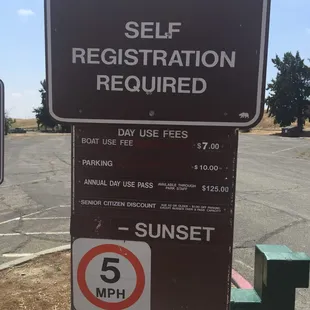 $10 parking fee self registration at green pedestal to right of sign.