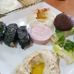 Sampler Combination of hummus, baba ghanouj, falafel and veggie grape leaves served with hot pita bread- was very good