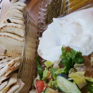 Labneh Smooth, creamy dip made of goat milk with delicious lemony taste, topped with olive oil,zhatar served with hot pita bread