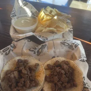 Asada tacos, queso, and chips
