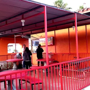 two people standing outside a restaurant
