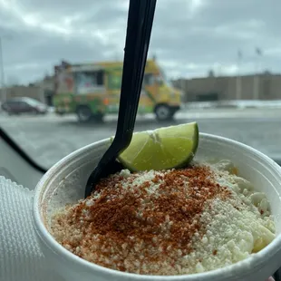 a hand holding a cup of food