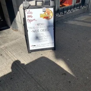 a sign on the sidewalk