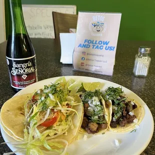 a plate of tacos and a bottle of beer