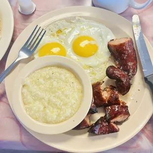 Two eggs, smoked sausage, and grits.