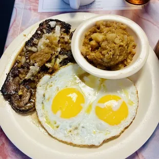 Two sunny side up eggs, Liver and onions, breakfast potatoes.