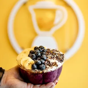 a hand holding a cupcake