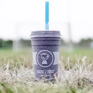 a purple drink with a blue straw