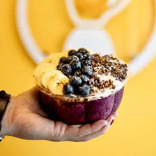 a person holding a bowl of fruit