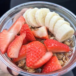 The Super Bowl with strawberries, bananas, granola, and honey.