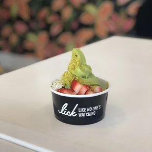 Matcha soft serve dusted with matcha powder &amp; topped with strawberries, crushed pistachio &amp; coconut.