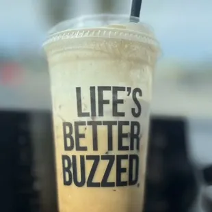 a drink in a plastic cup with a straw