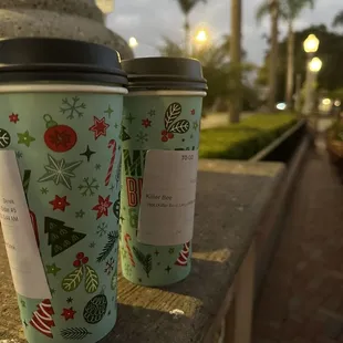 two cups of coffee on a ledge