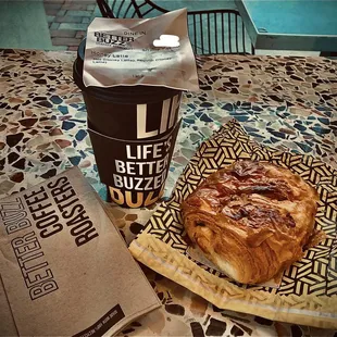 a cup of coffee and a pastry on a table