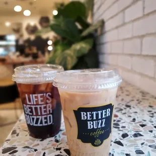 two cups of iced coffee on a table