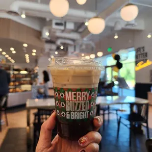 a hand holding a cup of coffee
