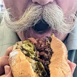 Lonny (@donutduster) devouring HWY55 Jalapeno Jack Cheesesteak with Bacon