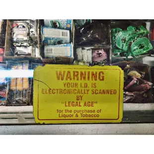 a sign warning of electronicly scanned by the legal age for the purchase of liquor in tobacco