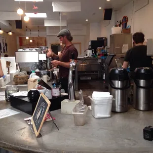 Barista with la marzocco and sparkling water tap.